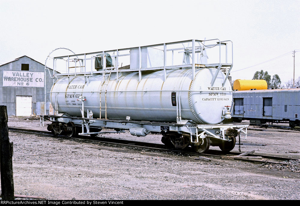 SPMW water car #6516 with ex economy baggage #6754 in background.